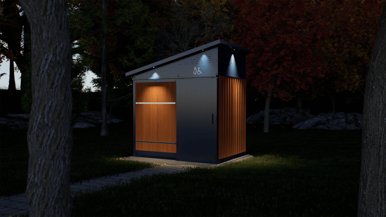 La toilette écologique NIX-01 illuminée dans un parc la nuit.